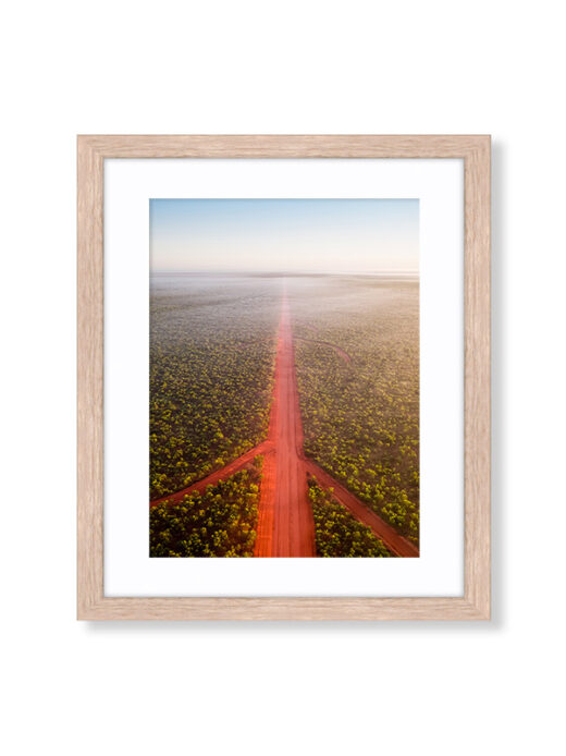 An Aerial Drone Photo of The Red Dirt Road at Sunrise in Broome Western Australia. Available as a Fine Art Framed Photo Print.
