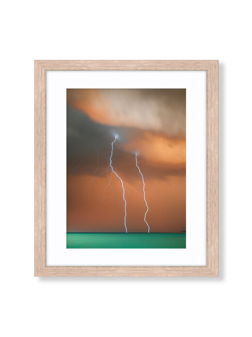 A Sunset Storm Photo of Lightning off Cable Beach in Broome Western Australia. Available as a fine art framed photo print.