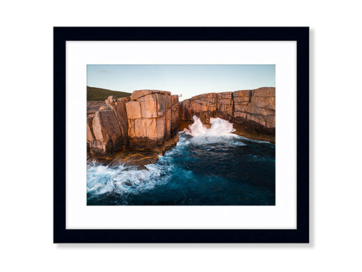 An Aerial Drone Photo of Sunset at The Gap and Natural Bridge in Albany Western Australia. Available as a fine art framed photo print.